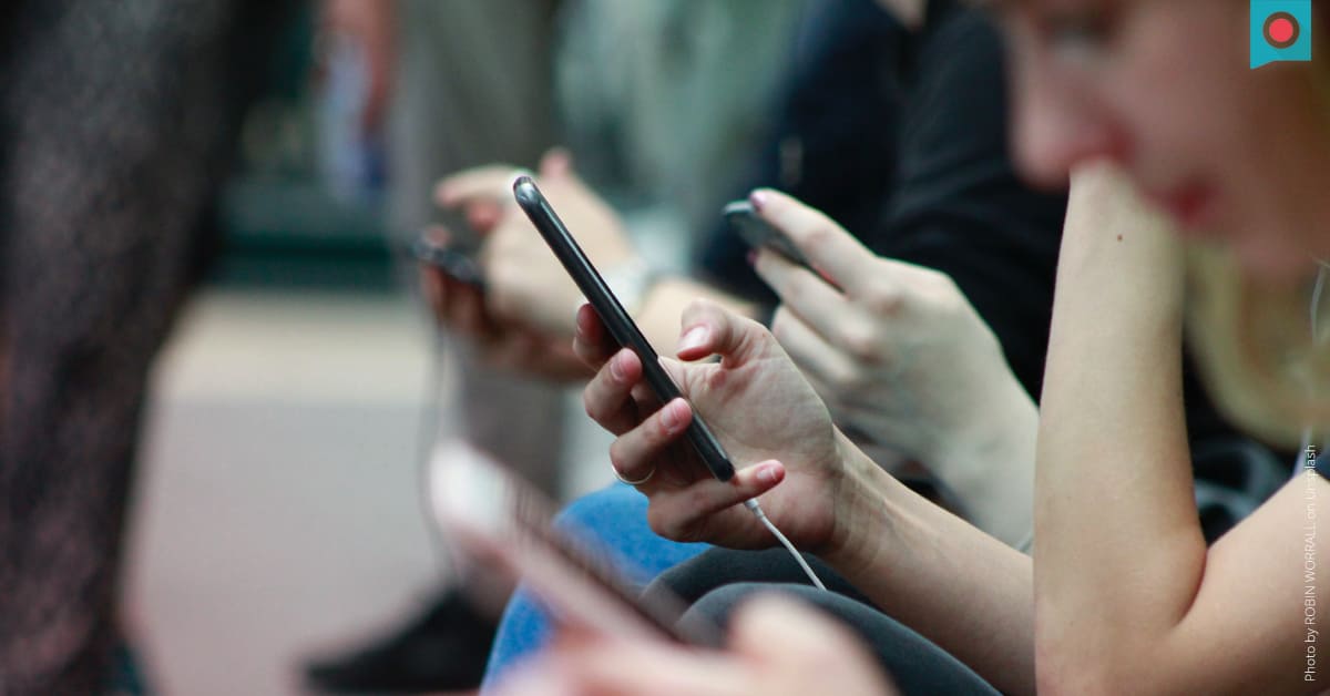 Gruppe Jugendlicher mit Smartphones in den Haenden