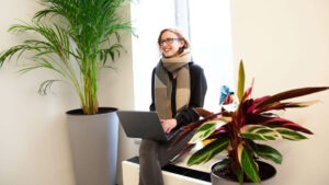 Mitarbeiterin beim Follow-Up Interview am Bürofenster