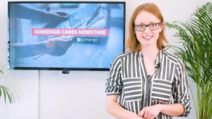 Mitarbeiterin vor Fernseher mit Vorschau auf Kampagne